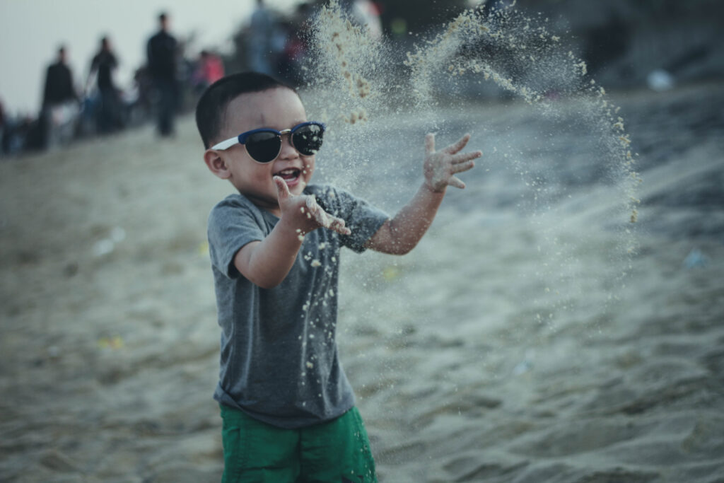 boy throwing sand