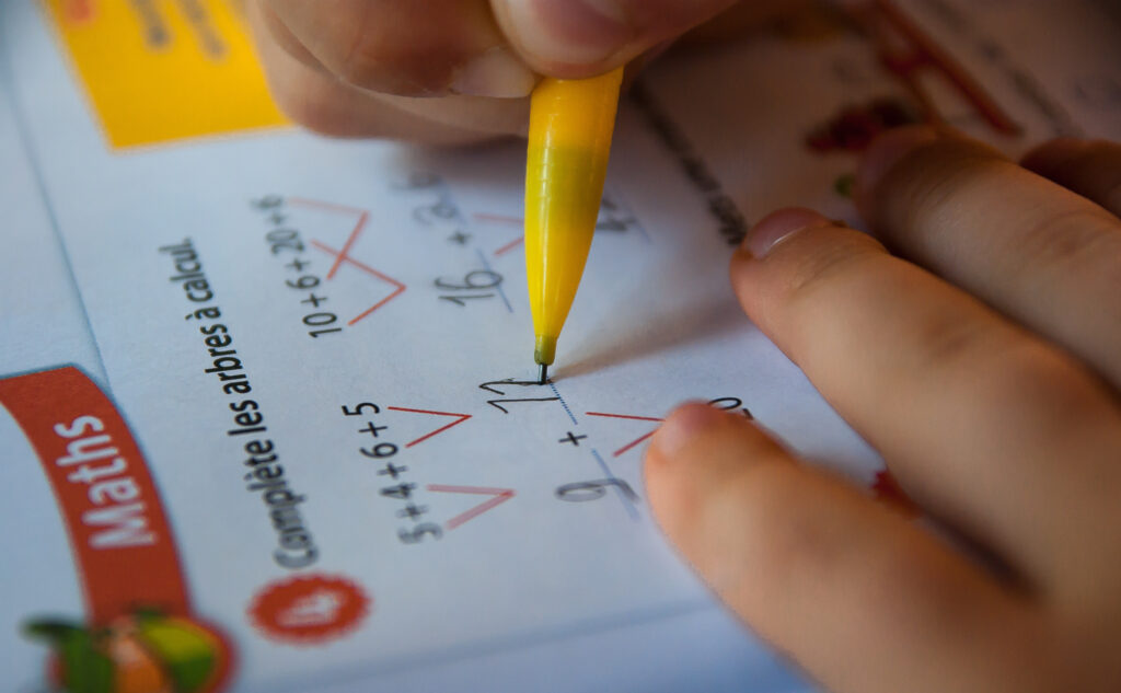 image of kid working on math